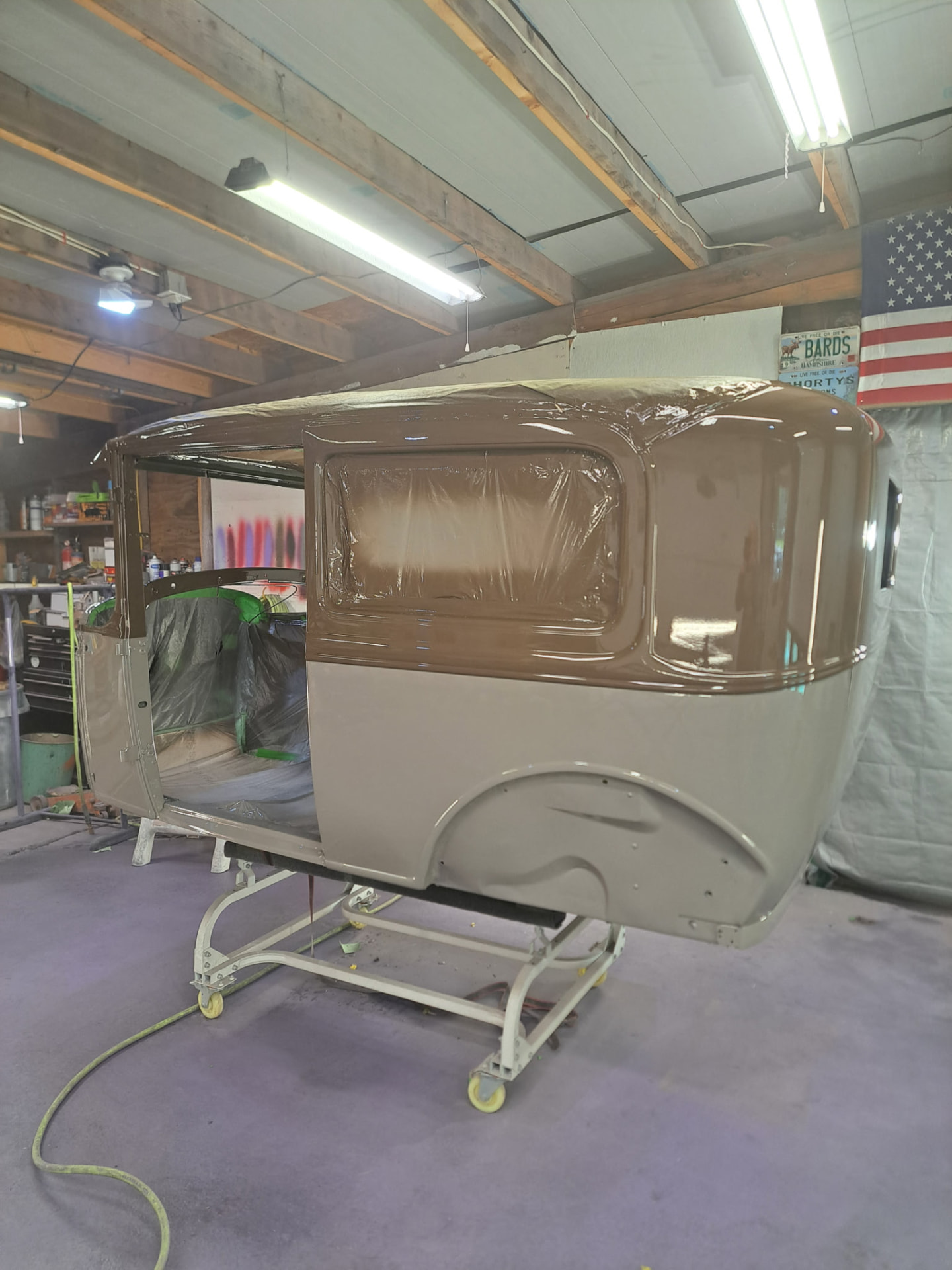 Two-tone vintage cab body freshly painted inside the workshop