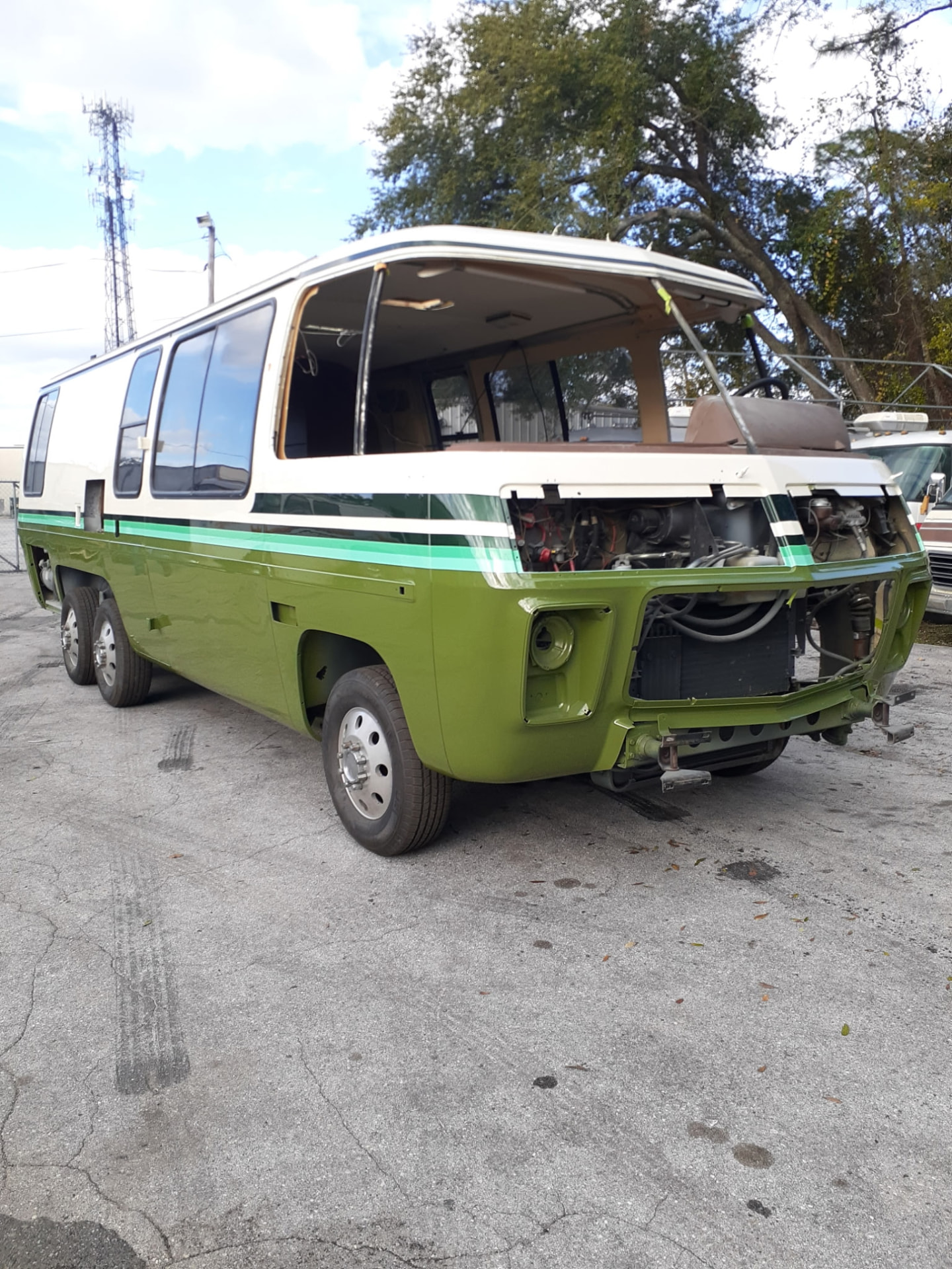 Green and white vintage bus being customized