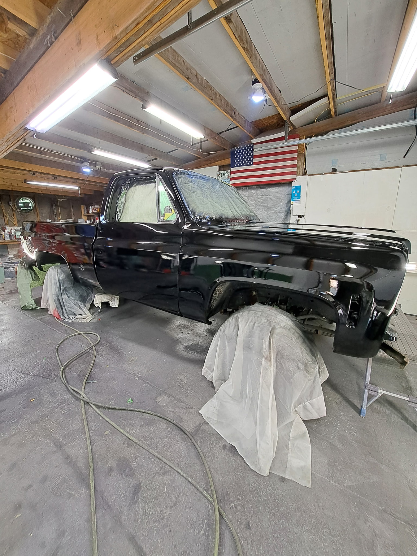 Glossy black pickup truck in the paint shop
